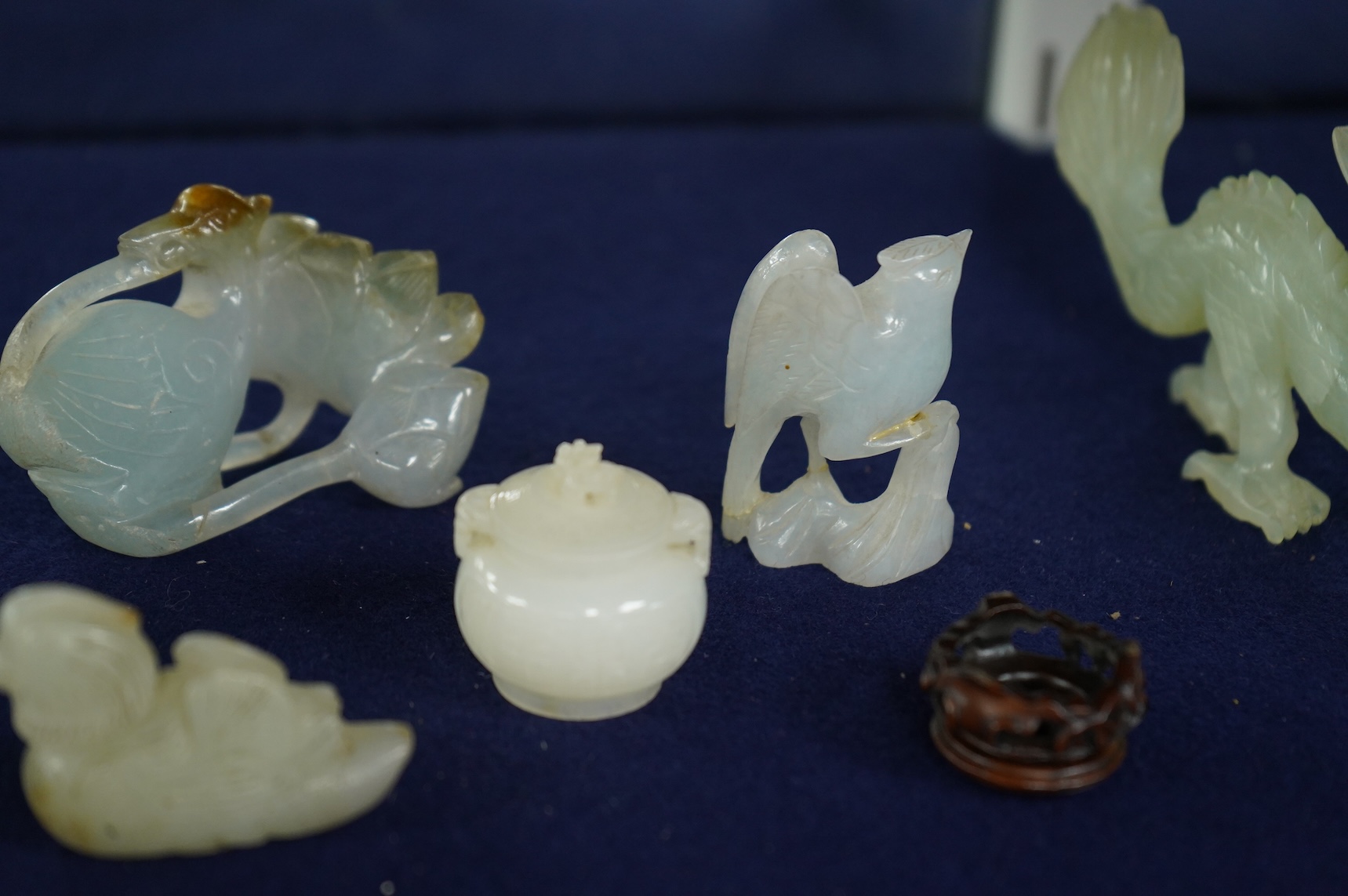 A Chinese jade figure of a Mandarin duck and a miniature pot and cover, three jadeite carvings and a bowenite dragon, 16.5cm